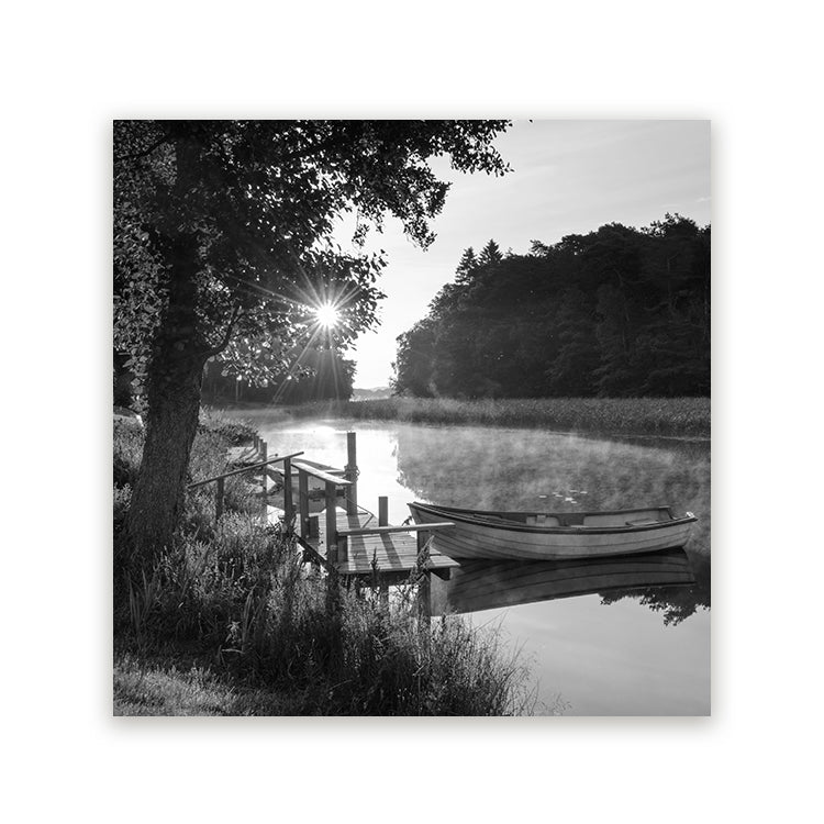 Zwart-wit schilderij van een boot aan een houten steiger op rustig water met zonlicht tussen de bomen